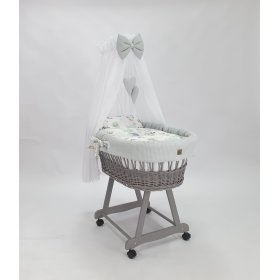 Rieten bed met uitrusting voor een baby - Egel